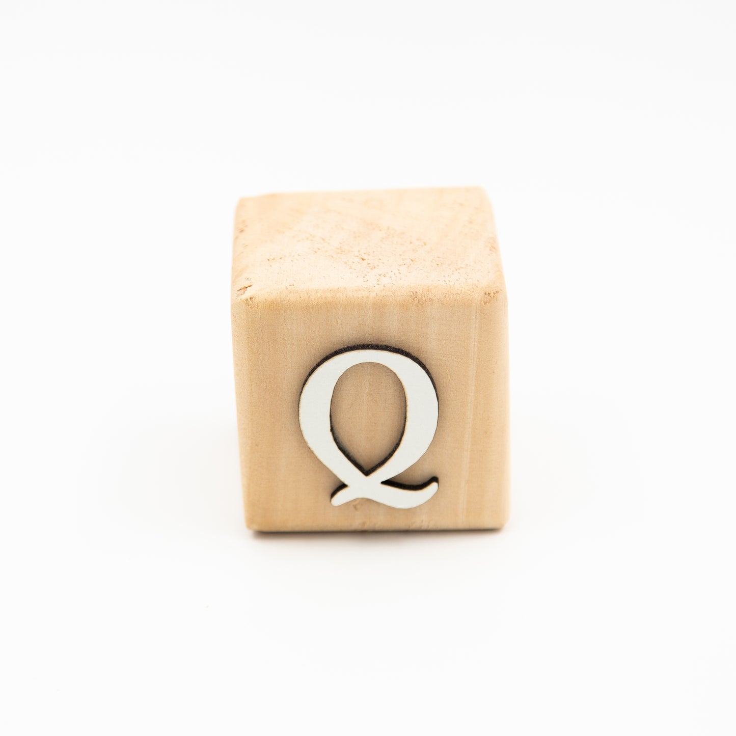 Wooden alphabet letter block Q.