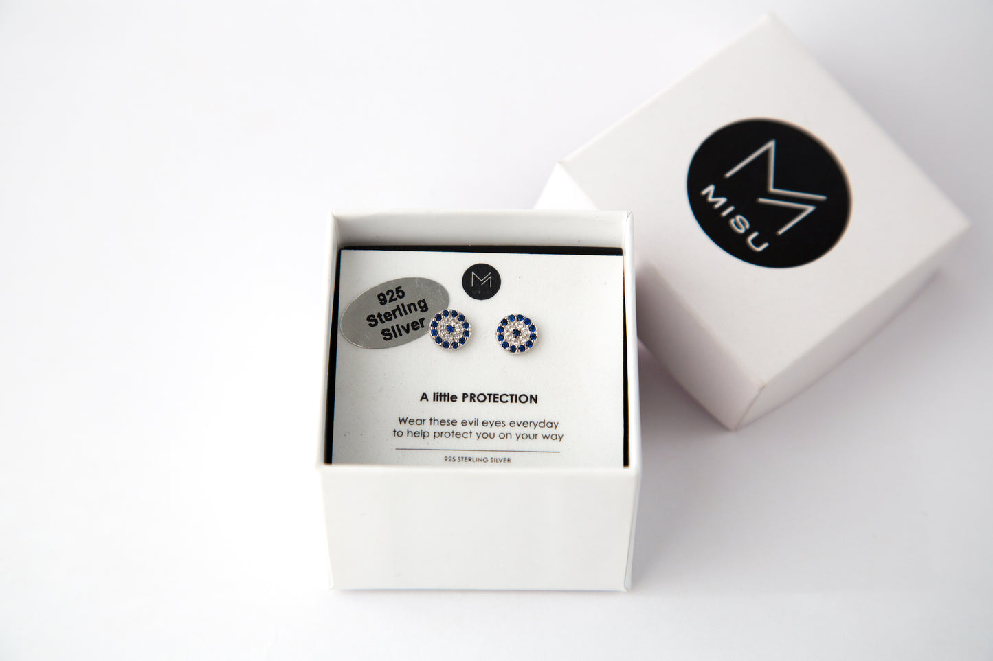 Silver evil eye protection earrings in a gift box.